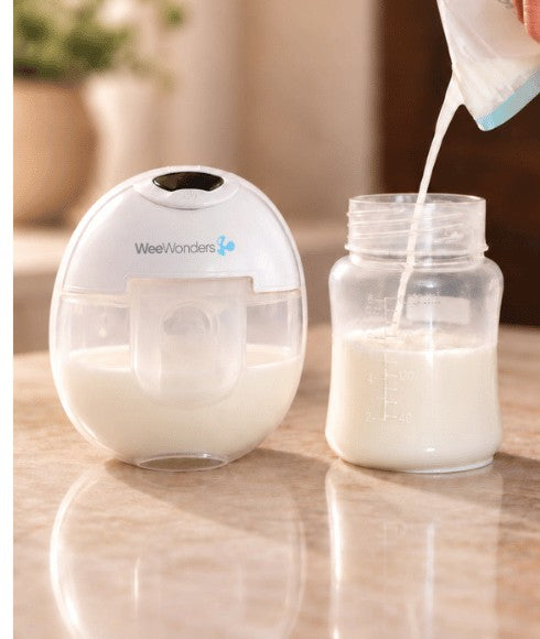 WeeWonders wearable pump in use, pouring milk into a bottle